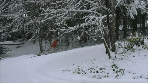 Oregon snow man pulls sled up hill 4k Stock Footage 40545540