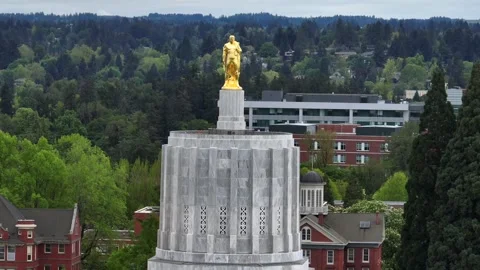Oregon State Capitol in Salem, Oregon, USA, with gold pioneer statue Stock Footage 334605697