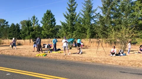 Oregon, USA - August 21, 2017: A group of people waits for the eclipse show Stock Footage 266725411