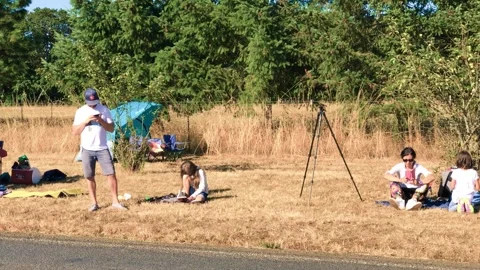 Oregon, USA - August 21, 2017: A group of people waits for the eclipse show Stock Footage 266725626