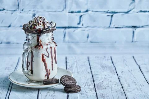 Oreo milkshake with sprinkling on the ceramic plate Stock Photos