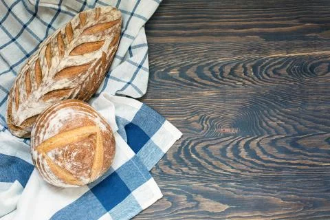 Organic artisan sourdough bread on the rustic table with free space on the right Stock Photos