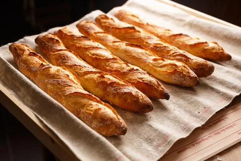 Organic baguettes in authentic bakery setting 写真素材