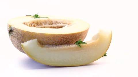 Organic cantaloupe melon with fresh basil on bright white background Stock Footage 340416162