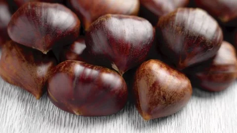 Organic chestnuts on aged rustic white board. Stock Footage 296648872