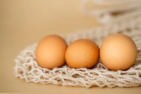 Organic chicken eggs lie on a string bag Stock Photos