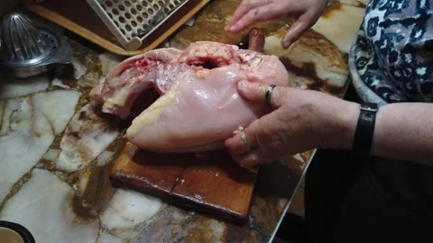 Organic Chicken Preparation CloseUp Elderly Hands Peel Raw Poultry, Home Kitchen Stock Footage 323888339