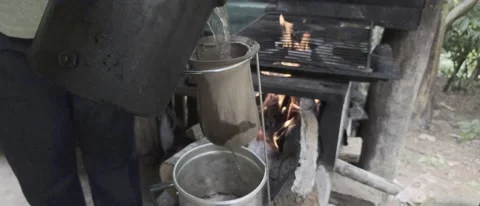 Organic coffee on the fire in a rustic wood stove Stock Footage 227232029