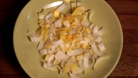 Organic corn  falling on endive green salad leaves Stock Footage 117236082