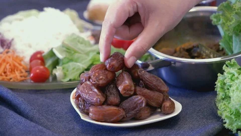 Organic dates palm fruit serving and picking on dining table Stock Footage 129664841