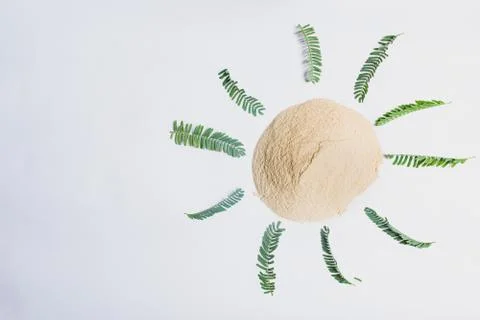 Organic dry clay powder on white background with herbs Stock Photos