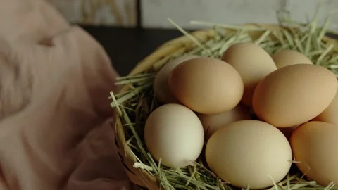 Organic eggs and hay in a wicker basket, Travel shot right Stock Footage 281036909