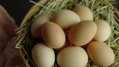 Organic eggs and hay in a wicker basket, Dolly in Close up Stock Footage 281036910