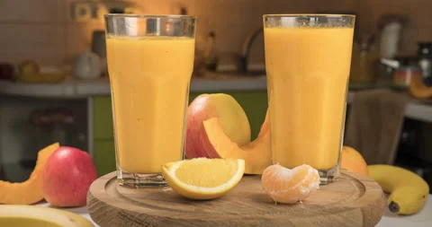 Organic Freshly Squeezed Fruit smoothie Into the Glass Stock Footage 166567571