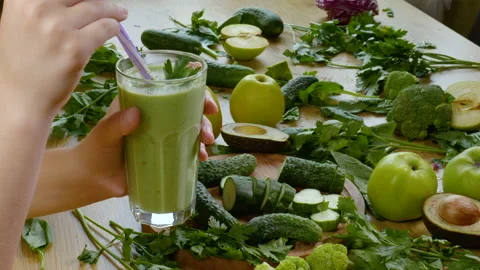 Organic Freshly Squeezed Green Vegetable and Fruit smoothie Into the Glass Stock Footage 158018698