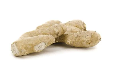 Organic ginger root placed on clear white surface. Stock Photos