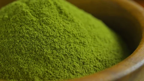 Organic Green Matcha Tea powder in wood bowl Stock Footage