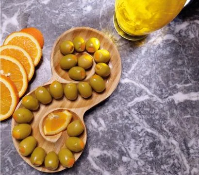 Organic green olive (spiral shaped) orange Stock Photos