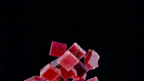 Organic jelly sugar candies exploding in slow motion, isolated black background Stock Footage 141986095