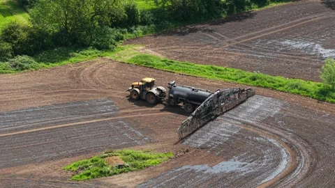 Organic manure fertilization tractor working across arable field for soil Stock-Footage 339342525