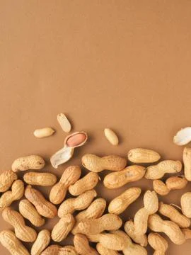 Organic peanuts on a brown background Stock Photos