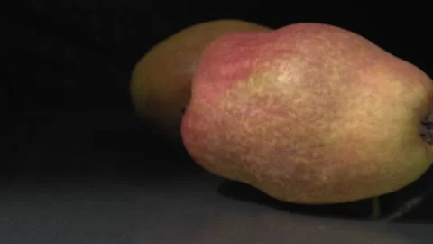 Organic pears close-up. Ripe fruit on a black background. 動画素材 144353232