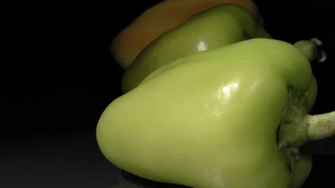 Organic pepper close-up. Black background. Fresh vegetables. Stockbeeldmateriaal 144353163