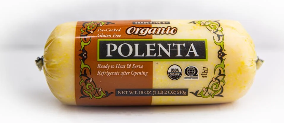 Organic polenta from Trader joe's in packaging on a white background Stock Photos