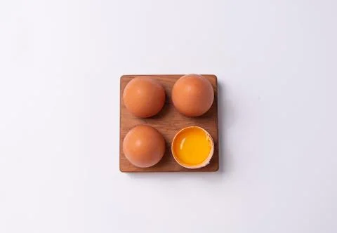 Organic raw eggs on a white background. Dark and light brown eggs. Stock Photos