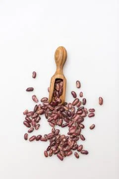 Organic red beans and olive wood scoop on whie background Stock Photos