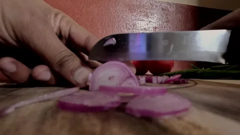 Organic Red Onion Slices Falling on Wooden Board - Kitchen Prep Stock Footage 341854227