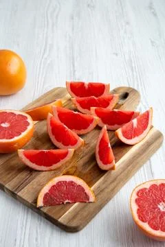 Organic Red Ruby Grapefruit on a Wooden Board, side view. Space for text. Stock Photos