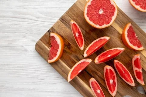Organic Red Ruby Grapefruit on a Wooden Board, top view. Overhead, from abo.. Stock Photos