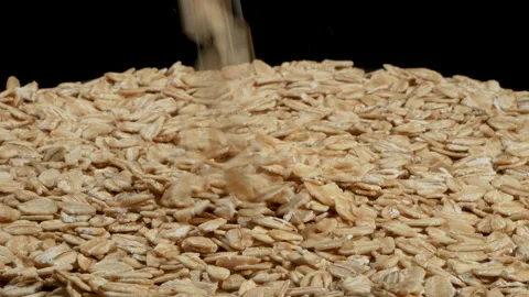 Organic Rolled Oats Falling in Slow Motion on Black Background. Stock Footage 333096092