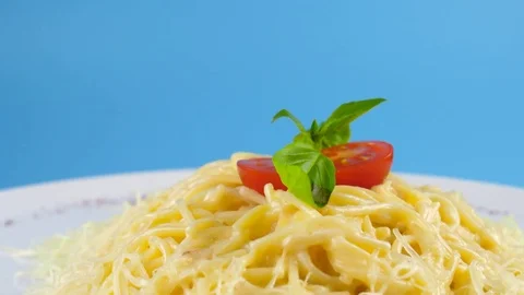 Organic Spaghetti with cheese, camera moves from bottom to up, blue background 스톡 동영상 78664713