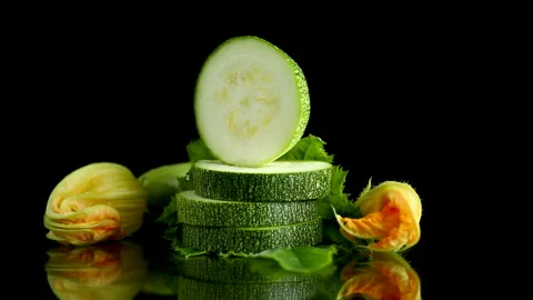 Organic squash vegetable with vibrant blossom on dark reflective background Stock Footage 340415880