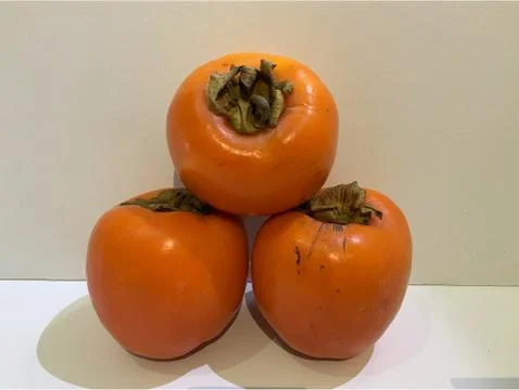 Organic Three Persimmon Stock Photos