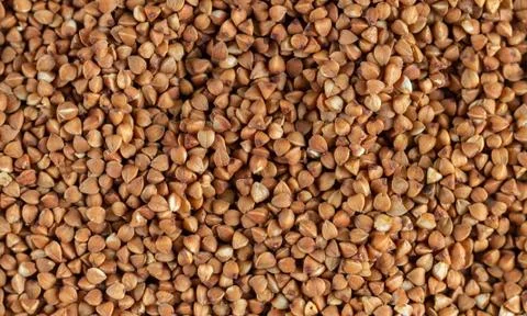 Organic uncooked buckwheat grain pattern background Stock Photos