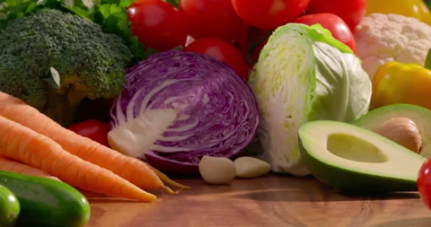 Organic vegetables background. Fresh cabbage broccoli tomatoes carrots cucumber Stock-Footage 313075764