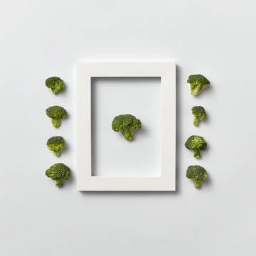 Organic vegetables pattern with broccoli in a frame and out of it on a ligh.. Stock Photos