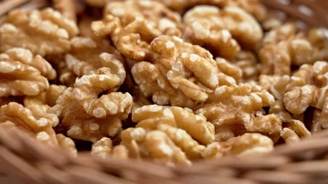 Organic walnut kernels nuts in rustic rattan wicker bowl. Stock Footage 273300001