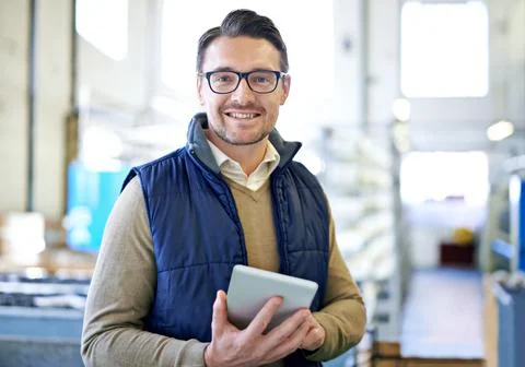 Organized and efficient. a man working in a large warehouse. Stock Photos