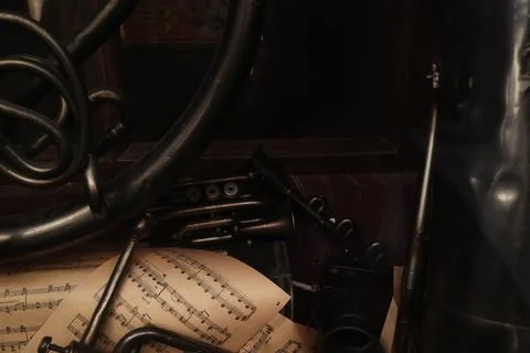 Organized array of sheet music placed on top of a wooden desk, viewed from a sli Stock Photos