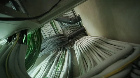 Organized bundle of insulated electrical and network cables in utility corridor Stock Footage 304986512