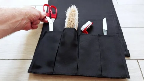 Organized Grooming: Packing Essential Tools into a Travel Pouch Video stock 312733398
