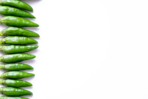 Organized horizontal rows of fresh green bird's eye chilies or cabe rawit hijau Stock Photos