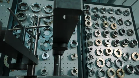 Organized industrial workshop wall displaying precision metal flanges, rings Stock Footage 335860990