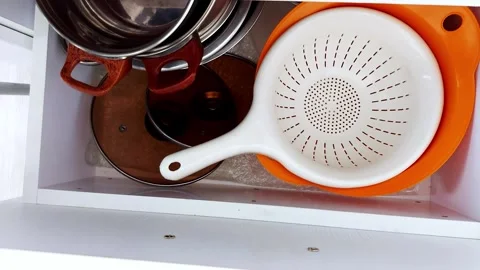 Organized Kitchen Drawer with Stainless Cookware and Colander Stock Footage 318208228