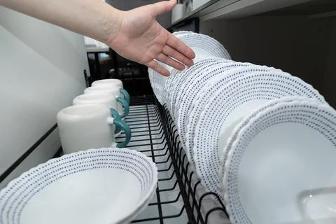 Organized Kitchen Drying Rack With Clean Dishes and Mugs Ready for Use Afte.. Stock Photos