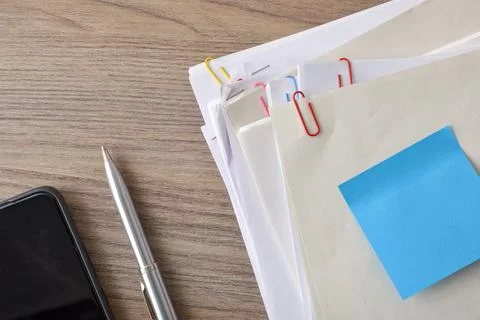 Organized Office Documents with Pen and Sticky Note Stock Photos